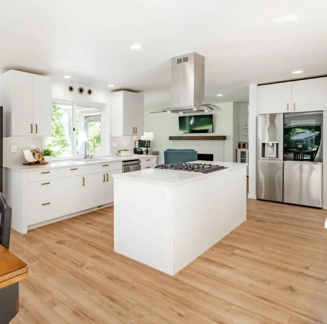 Modern kitchen with island and hardwood floor.