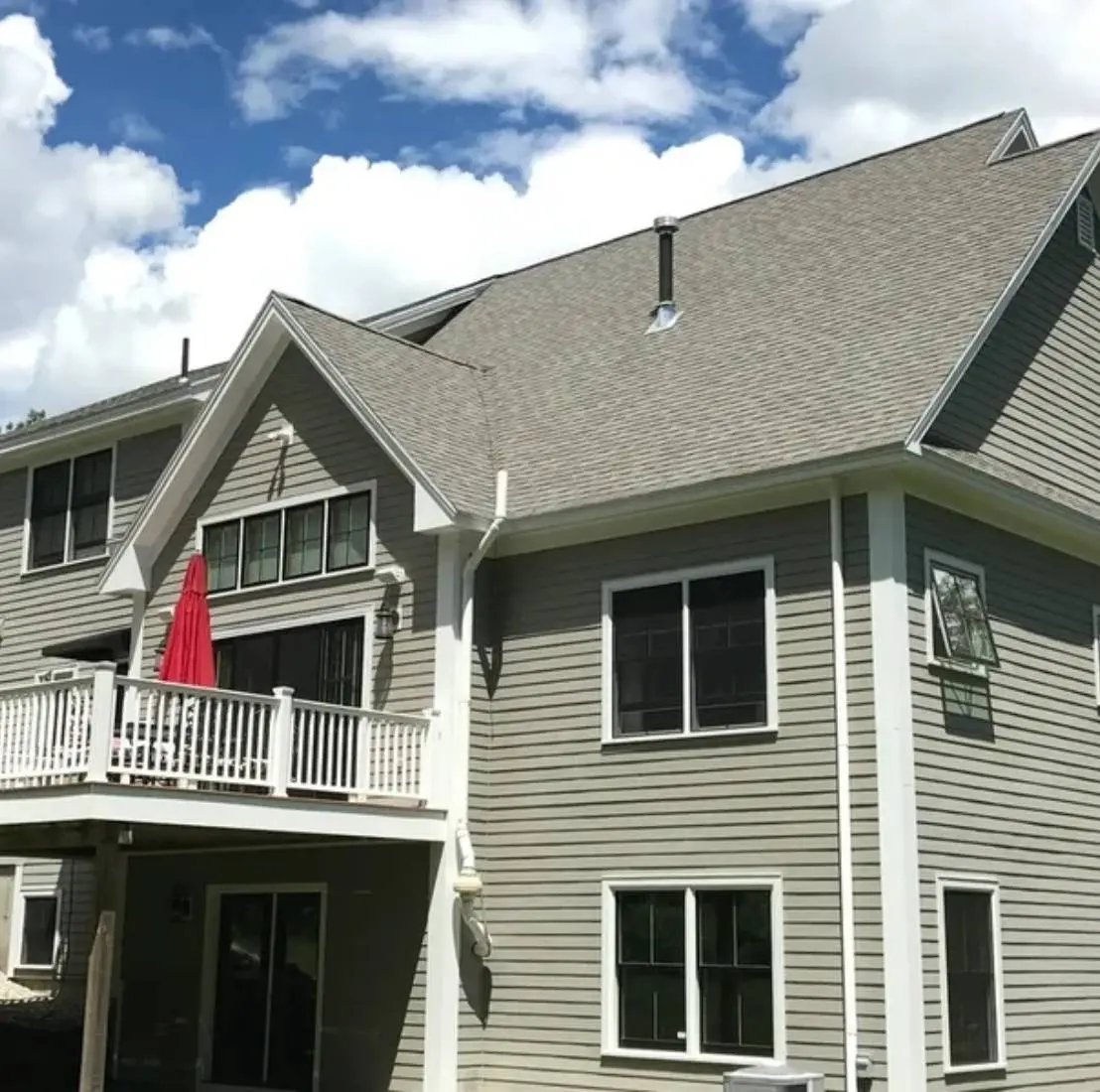 Two-story house with a backyard deck.