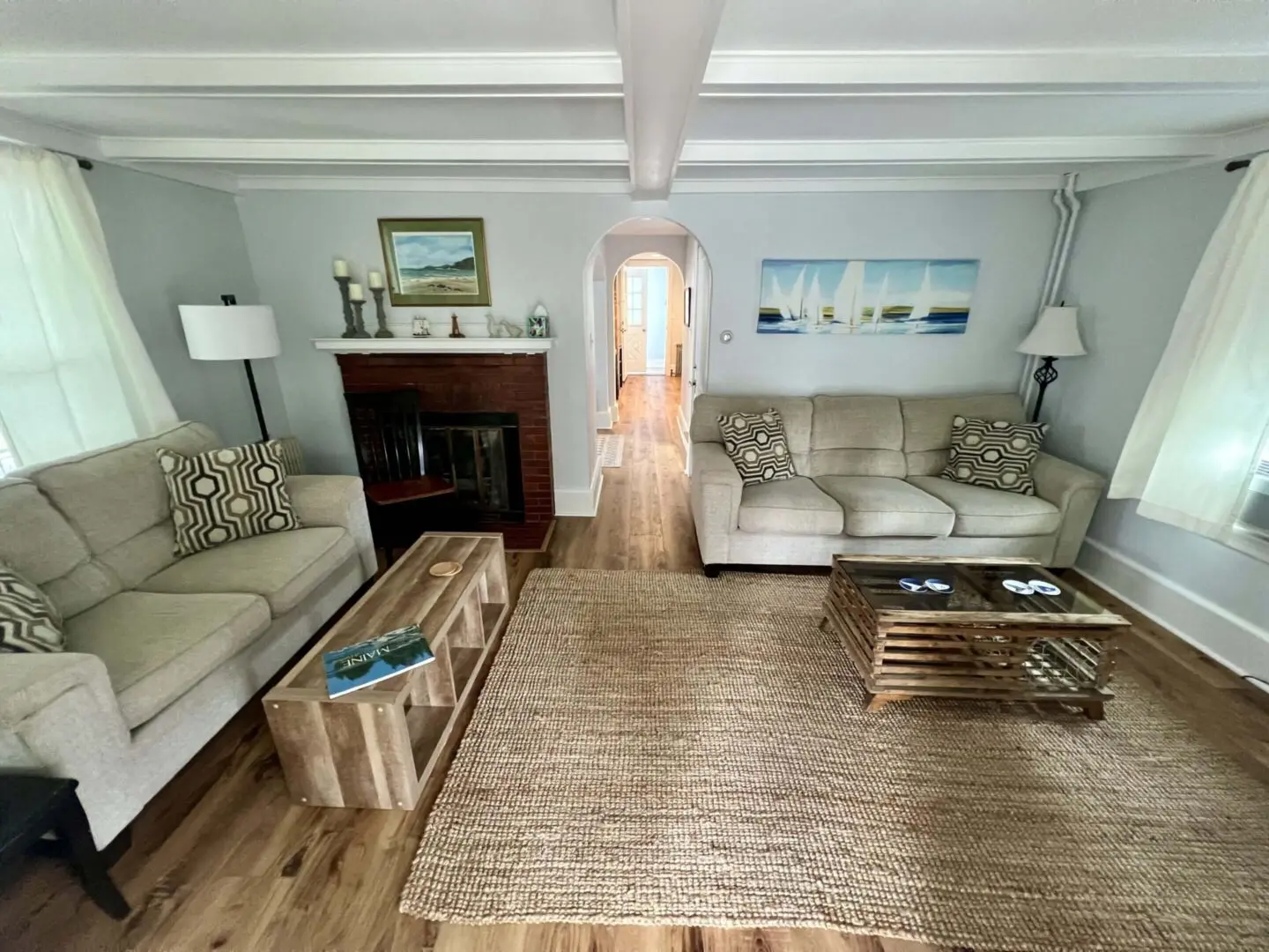 Cozy living room with sofas and fireplace.